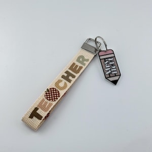 Pulsera de profesora neutra y llavero a juego