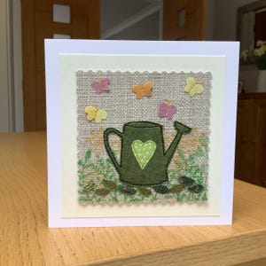 Sewn fabric watering can,  cottage garden scene, textile art greetings card.