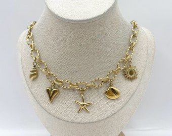 Charm necklace for summer featuring seashells, starfish, sun, and clams in stainless steel.