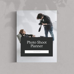 May include: A photo shoot planner with a black cover and the title "Photo Shoot Planner" in white. The image shows a person taking a photo of a person sitting in a chair.