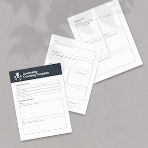 May include: A stack of white paper templates for coaching and leadership. The top sheet has the text "Coaching Plan". The bottom sheet has the text "Leadership Coaching Template" with client information and a coaching agreement section.