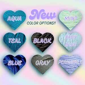 May include: Image showcasing nine heart-shaped yarn samples in various colors: aqua, mint, teal, black, baby blue, blue, gray, and periwinkle. The text "New COLOR OPTIONS!!" is displayed above the hearts, indicating new color choices.