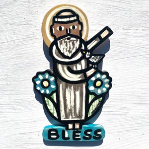 Peut inclure: Icône religieuse peinte à la main, représentant une figure avec un halo, tenant un oiseau et un bâton. La figure est flanquée de fleurs bleues et le mot "BLESS" est à la base. L'œuvre est de style art populaire.
