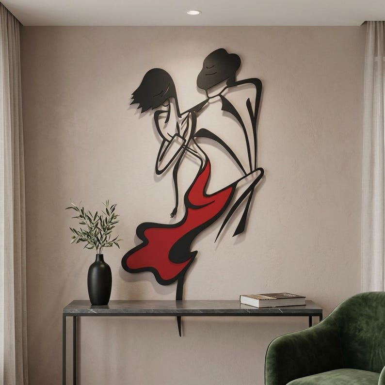 May include: A black metal wall art piece depicting two figures in a dancing pose, with one figure wearing a flowing red dress. The design features clean, continuous lines and minimalist silhouettes, creating a dynamic sense of movement.