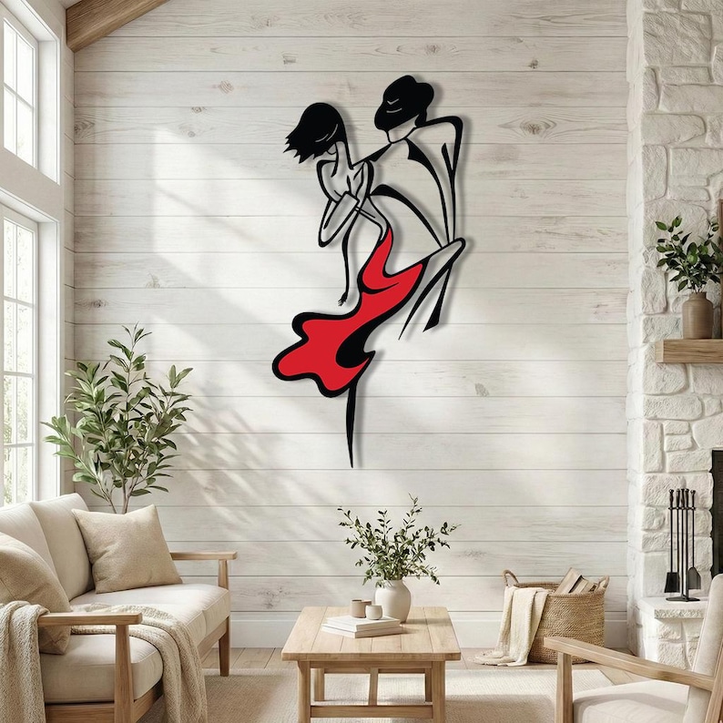 May include: A wall-mounted metal art piece depicting a stylized dancing couple. The design features black outlines of two figures, with the dancer wearing a flowing red dress. The artwork is composed of clean, minimalist lines and solid color fills.