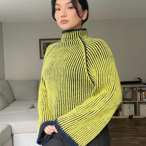 May include: A white ceramic mug with a black handle and the text "But First, Coffee" in a black, handwritten-style font. The mug is on a white surface.