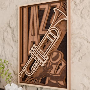 May include: A layered wooden artwork with the word "JAZZ" and a trumpet design. The piece uses various shades of brown and tan wood to create a 3D effect. The trumpet is angled across the artwork.