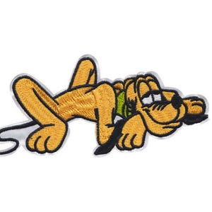 May include: An embroidered iron-on patch featuring a cartoon dog with a brown and yellow body, black eyes, and a black nose. The dog is lying on its side with its head resting on its paw.