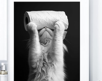 May include: A black and white framed wall art print featuring a fluffy cat holding a roll of toilet paper over its head. The text Mockup & Design Created with AI is visible at the top. The cat has long fur and is looking upward at the paper roll.