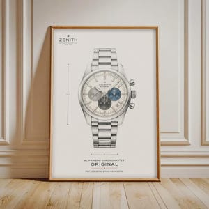 May include: A framed technical illustration of a Zenith El Primero Original chronograph watch. The print features a silver-toned watch with a metal link bracelet, three sub-dials, and technical markings including the text Zenith El Primero Original.