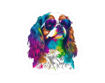 May include: A colorful sticker featuring a Cavalier King Charles Spaniel wearing sunglasses. The dog's fur is a vibrant mix of rainbow colors, including pink, blue, yellow, and orange. The sunglasses have a silver frame and dark lenses, adding a cool, stylish touch.