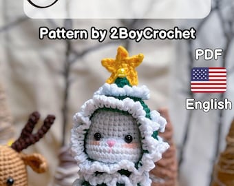 May include: Crocheted Christmas tree toy with a white face and green and white body. The toy is wearing a white crocheted hat with a yellow star on top. The pattern is available in English as a PDF download.  Pattern by 2BoyCrochet.