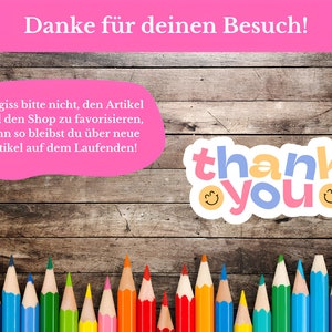 May include: A pink and white thank you card with a wooden background. The card has a message in German that says "Danke f&uuml;r deinen Besuch!" and a sticker that says "thank you" with smiley faces. There are colored pencils lined up at the bottom of the card.