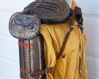 Post apocalyptic style pauldron made from perforated steel and scrap.