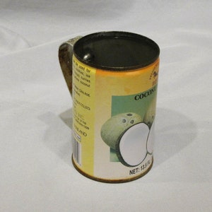 Rusty tin can made into a mug