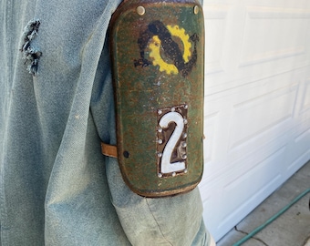 Heavy steel shoulder armor with graphics.