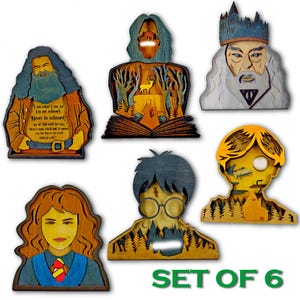 May include: A set of six wooden Harry Potter character cutouts. Each cutout depicts a different character, such as Hagrid, Dumbledore, and Harry Potter. The cutouts are in shades of brown, yellow, and blue, with detailed layered designs and text.