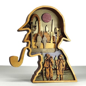 May include: A multi-layered wooden sculpture in the shape of a detective's silhouette, complete with a hat and pipe. The interior depicts a city scene with figures and buildings. The sculpture is made of various wood tones and has a circular accent.