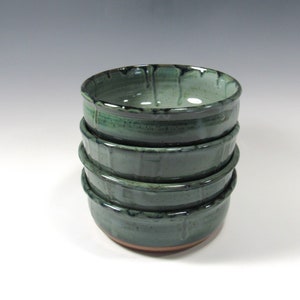 Set of 4 stoneware pottery bowls for soup, salads, chili, dips, etc. Glaze is blue green with darker drips around the rim. The 4 bowls are stacked.