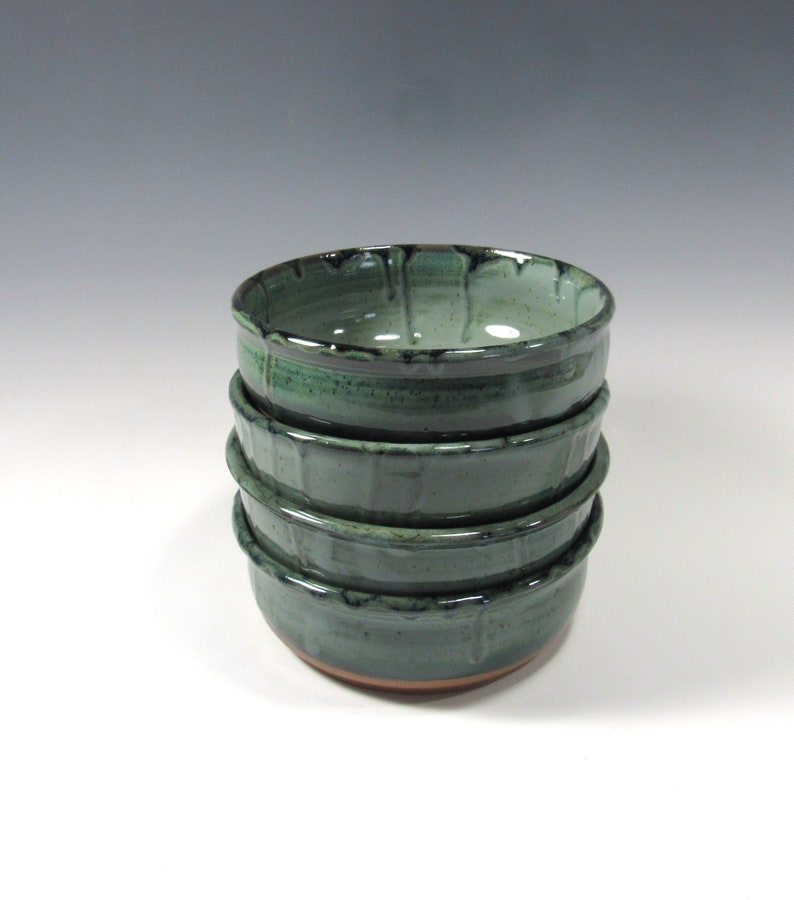 Set of 4 stoneware pottery bowls for soup, salads, chili, dips, etc. Glaze is blue green with darker drips around the rim. The 4 bowls are stacked.