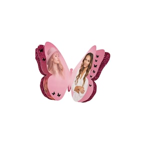 May include: A pink butterfly-shaped decoration with glitter edges and two images of women. The butterfly has a layered design with a lighter pink center and darker pink glitter edges. Small black butterfly cutouts are scattered on the wings.