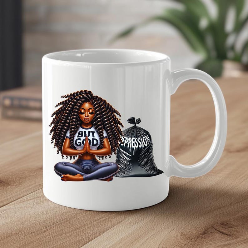 May include: White ceramic mug with a black and white illustration of a woman meditating with the text "But God" on her shirt. A black trash bag with the word "Depression" written on it is behind her.