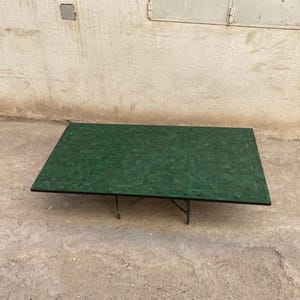 May include: A white ceramic mug with a black handle and the text "But First, Coffee" in a black, bold font. The mug is on a wooden surface. The mug is 10 cm tall.