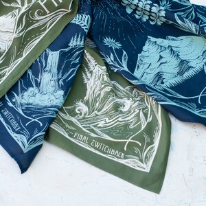 May include: Three green and blue bandanas with white illustrations of mountains, trees, and water. The bandanas have the text "Final Switchback" printed on them.