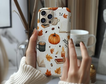May include: A white smartphone case featuring a repeating autumn-themed pattern of orange pumpkins, brown books, steaming mugs of coffee, lit candles, acorns, and golden maple leaves scattered across the surface in a detailed graphic illustration.