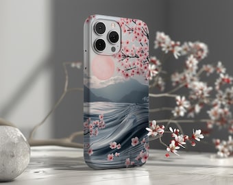 May include: A phone case featuring a design of a blue ocean with waves and pink cherry blossoms. The case has a white background and a black camera lens.