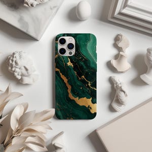 May include: A green and gold marble phone case with a modern abstract design. The case is designed for an iPhone.