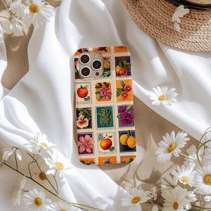 May include: A colourful phone case with a vintage design featuring a grid of squares with images of fruit, flowers, and leaves. The case has a white background with a light brown border.