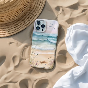 May include: A white phone case with a painted image of a beach scene. The case features blue ocean waves, a sandy beach, and seagulls flying overhead.