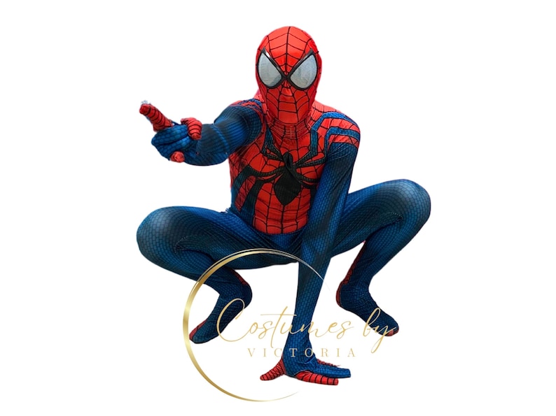 May include: A child dressed in a red and blue Spiderman costume with a black spider logo on the chest. The costume has a textured fabric and the child is in a crouching pose.