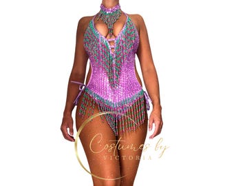 May include: A pink, green, and red beaded dance costume with fringe. The costume has a halter neckline and a low back. The costume is made of sequins and beads.