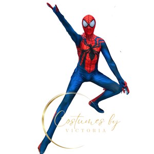 May include: A person wearing a red and blue Spiderman costume with a black spider design on the chest. The person is in mid-air with one arm raised and the other arm bent at the elbow. The person is wearing a red mask with black eyes.