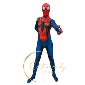 May include: A child wearing a red and blue Spiderman costume with a black spider design on the chest. The costume has a mask with a red and black design.