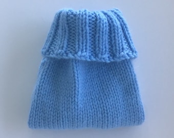 May include: A light blue knitted baby hat with a ribbed brim. The hat is made of soft yarn and has a folded brim. The hat is designed to keep a baby's head warm.