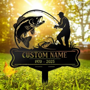 May include: Black metal silhouette of a fisherman casting a line with a fish jumping out of the water. The sign reads "CUSTOM NAME 1970 - 2025".
