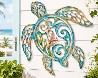 May include: A metal wall art piece shaped like a sea turtle with an intricate cutout design. The turtle features a weathered finish in shades of teal, blue, and gold, with a coral-like structure depicted in the center of its shell.
