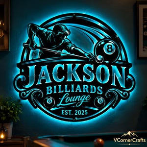 May include: A circular wall sign featuring bright blue LED backlighting. The design depicts a person playing billiards with a cue stick and an eight ball. Text reads JACKSON BILLIARDS Lounge EST. 2025. The sign has a black finish.