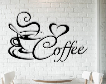 May include: Black metal wall art depicting a coffee cup with steam, a heart shape, and the word "Coffee" in a cursive style. The artwork is mounted on a white brick wall, suitable for a cafe or kitchen.
