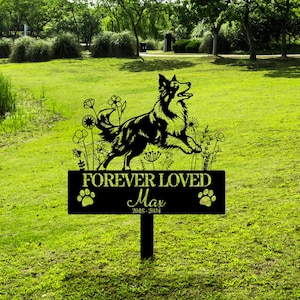 May include: Black metal memorial sign with a silhouette of a dog, flowers, and the text "FOREVER LOVED Max 2018-2024".