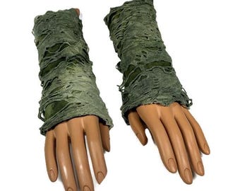 May include: A pair of green distressed fabric arm warmers. The arm warmers are made of a soft, stretchy fabric with a distressed look. They are perfect for adding a touch of style to any outfit.
