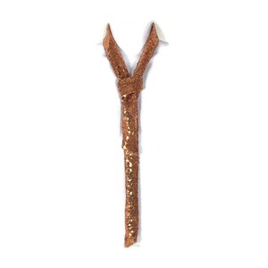 May include: A gold sequined tie. The tie is tied in a knot and hangs down. The tie is on a white background.