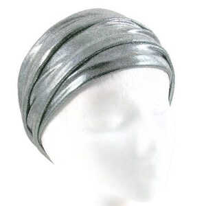 May include: A silver metallic turban headband. The headband is made of a soft, stretchy fabric and is designed to be worn as a head wrap.