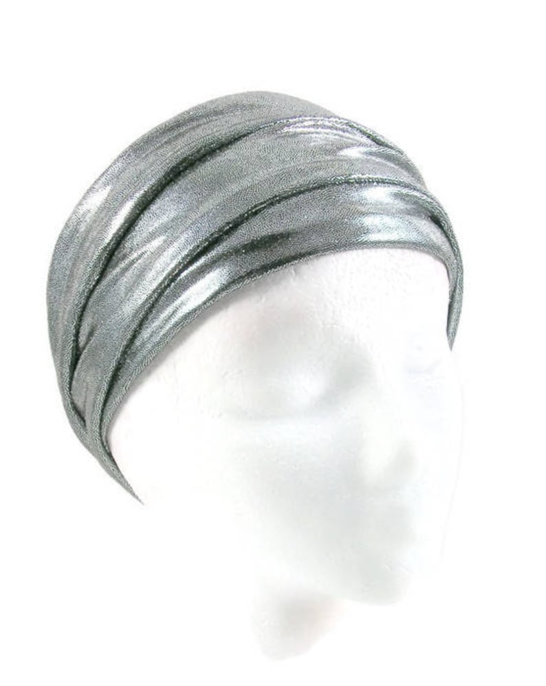 May include: A silver metallic turban headband. The headband is made of a soft, stretchy fabric and is designed to be worn as a head wrap.
