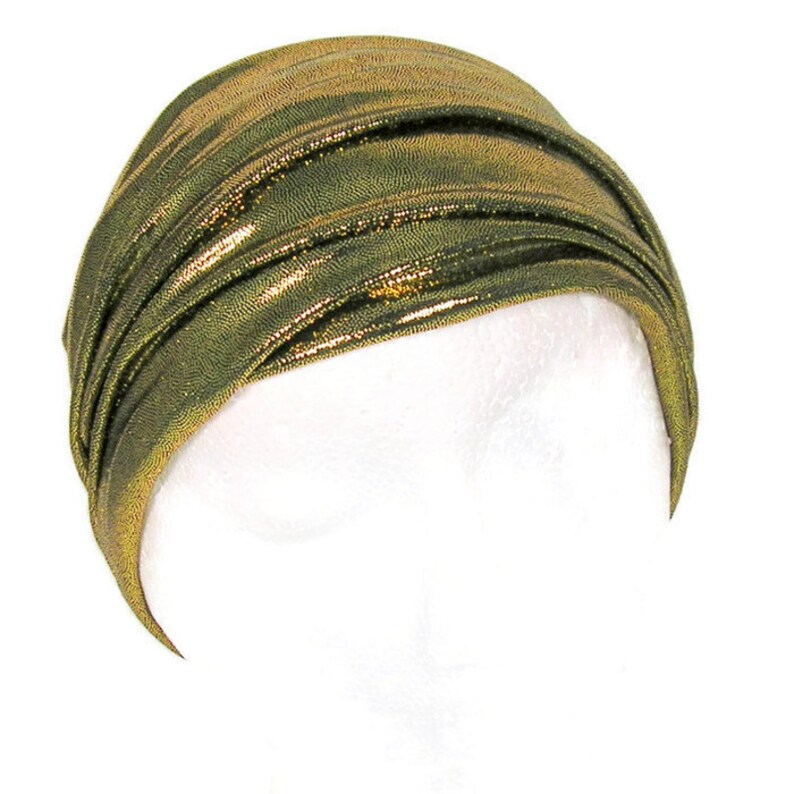 May include: A gold metallic turban headband with a shiny finish.