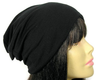 May include: A black beanie made of soft, stretchy fabric. The beanie is slouchy and has a simple design.