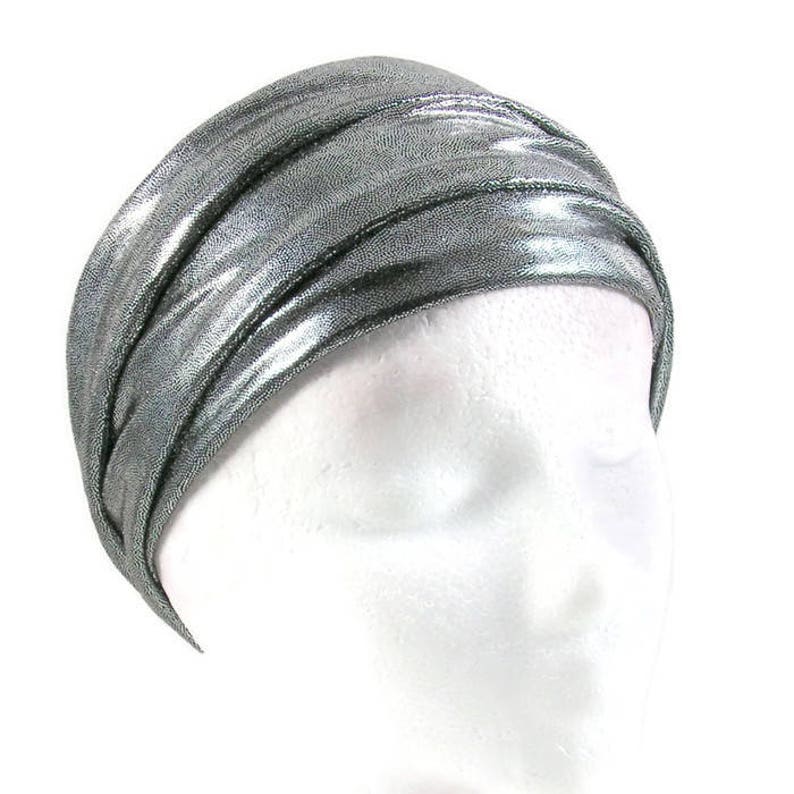 May include: A silver metallic turban headband with a shiny finish.